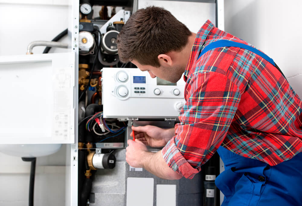 technician repairing heating system