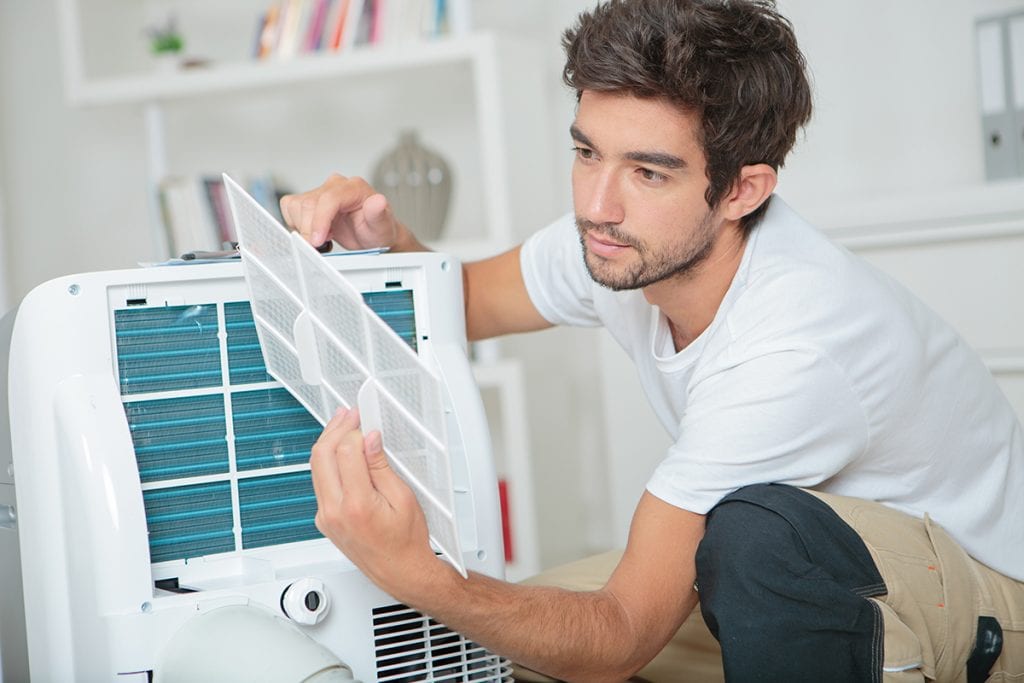 Man Checking the Air Conditioner Filters